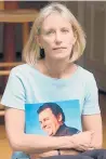  ?? AP ?? Beverly Eckert holds a photo of her husband, Sean Rooney, who died in the Sept. 11, 2001, attacks. She died in a plane crash in 2009.