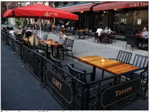  ?? (AP) ?? Customers dine outside GMT Tavern in New York in June. Included in the new emergency relief package is a provision to restore full tax breaks for restaurant business meals.