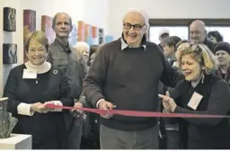  ?? BY GARY ANTHES ?? Washington Mayor John Fox Sullivan, center, in December as he officially opened the Middle Street Gallery on its return to the county seat after an absence of six years.