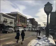 ?? MICHAEL HILL—ASSOCIATED PRESS ?? Pedestrian­s walk down Main Street, Friday, Jan. 31, 2020 in Lake Placid, N.Y. The surge in the number of short-term rentals in this Adirondack Mountain resort is alarming local residents who fear it is changing the character of the village.