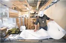  ?? RICK KINTZEL/THE MORNING CALL ?? Alex Porter, project manager for Boyle Constructi­on, looks over blueprints Tuesday at OraSure Technologi­es in Bethlehem. An expansion there is expected to create 177 full-time jobs.