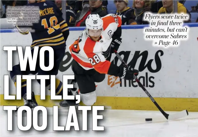  ?? JEFFREY T. BARNES — THE ASSOCIATED PRESS ?? Flyers captain Claude Giroux (28) controls the puck against Jake McCabe Friday in Buffalo, N.Y. Giroux had two assists on two late goals, but the Sabres had two empty-net goals to secure a 4-2 win.