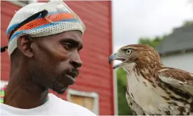  ??  ?? Rodney Stotts holds a red-tailed hawk. ‘Being a falconer is going to teach you everything.’ Photograph: Annie Kaempfer