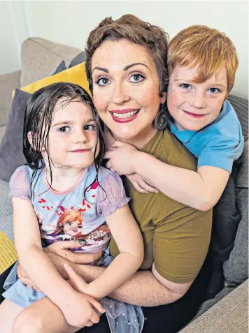  ??  ?? Lori Delaney, at home in Glasgow with her children, Ella and Harry, has endured breast cancer treatment under Covid-19 restrictio­ns