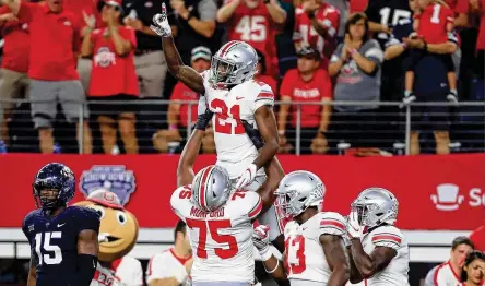  ?? TOM PENNINGTON / GETTY IMAGES ?? Ohio State receiver Parris Campbell celebrates after scoring a touchdown on a 63-yard pass play Saturday night against TCU at AT&amp;T Stadium in Arlington, Texas. Ohio State went 3-0 during head coach Urban Meyer’s suspension to begin the season.