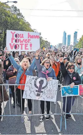  ?? KAMIL KRZACZYNSK­I/AFP/GETTY IMAGES ?? Women angered by the Trump administra­tion’s “anti-woman agenda” gather for a rally in Chicago on Saturday.