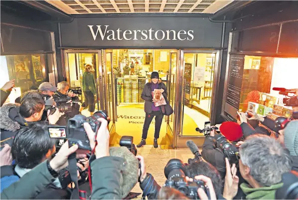  ?? ?? Caroline Lennon, the first person to buy Spare at a deserted Waterstone­s in London’s Piccadilly yesterday morning. ‘I like Harry and Meghan and I don’t care what anybody says about me,’ she said