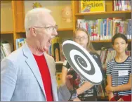  ?? Westside Eagle Observer/SUSAN HOLLAND ?? Alan Burdick, a magician from Lowell, tells the children at Gravette Public Library’s “Mission Accomplish­ed” program about black holes. The presentati­on was one of several mystifying tricks Burdick performed during his show at the summer reading program’s annual finale Tuesday, July 9, at the library.