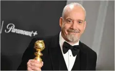  ?? ?? US actor Paul Giamatti poses in the press room with the Best Performanc­e by a Male Actor in a Motion Picture - Musical or Comedy award for “The Holdovers”.