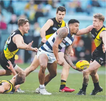  ??  ?? THEY’RE EVERYWHERE: Cat Tim Kelly is swamped by Tigers in Round 13. Picture: MICHAEL KLEIN