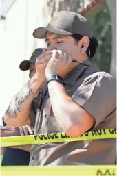  ?? ERIC RISBERG, AP ?? UPS workers gather outside after a reported shooting at a warehouse and customer service center in San Francisco on Wednesday. Police confirmed a shooting at the facility in the Potrero Hill neighborho­od.