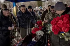  ?? DANIEL BEREHULAK — THE NEW YORK TIMES ?? Mourners at a funeral for Oleksiy Lytvynov, a Ukrainian soldier, in Boryspil near Kyiv, Ukraine, on Sunday.