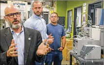  ?? LOUIS DELUCA / DALLAS MORNING NEWS ?? University of North Texas professor Guido Verbeck talks about the breath analyzer; behind him are co-creator Tom Kiselak (right) and Tim Wing, InspectIR co-founder.