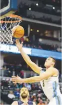  ?? Brent Lewis, The Denver Post ?? Nuggets forward Danilo Gallinari goes up for an easy layup against the Memphis Grizzlies at the Pepsi Center on Thursday night.