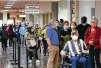  ?? Jerry Lara / Staff photograph­er ?? People line up for the Moderna COVID-19 vaccine administer­ed by University Health at Wonderland of the Americas mall.