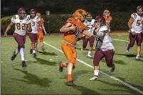  ?? ?? Arcata quarterbac­k Alex Jioras uses some arm to get into the end zone for a two point conversion