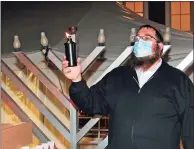  ?? Christian Abraham / Hearst Connecticu­t Media ?? Chabad of Fairfield Rabbi Shlame Landa prepares to light the menorah to celebrate Hanukkah in 2020.