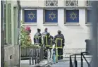  ?? ?? Firefighte­rs at the synagogue in Rouen that was set on fire yesterday