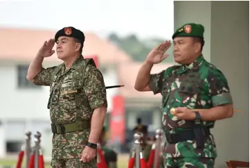  ??  ?? Toh (left) and Subiyanto salute their men during the opening ceremony of the Kekar Malindo training exercise.