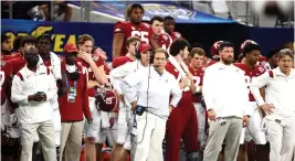  ?? AP Photo/Michael Ainsworth ?? ■ Alabama coach Nick Saban, center, watches from the sideline during the first half of the Cotton Bowl against Cincinnati on Dec. 31, 2021, in Arlington, Texas.