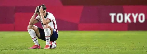  ?? Andre Penner / Associated Press ?? Team USA veteran Carli Lloyd is devastated after a stunning 1-0 loss to eventual champion Canada in the women’s soccer semifinals.