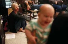  ?? BRYNN ANDERSON — THE ASSOCIATED PRESS FILE ?? In this file photo, Denise Wilkes, left, looks at baby Noah Burton, sitting on a fellow worshiper’s lap, during a church service in Birmingham, Ala. Emma and Liam were the most frequently chosen baby names for 2017. For the fourth year in a row, Emma...