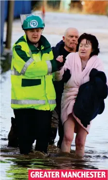  ??  ?? Rescue: A resident driven out by the floods in Bury GREATER MANCHESTER