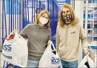  ?? (Courtesy Photo) ?? Alyssa Allen and Lake Musgrave leave the store in November after shopping for warm coats to distribute in Allen’s third annual Give Warmth clothing drive.