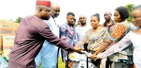  ?? ?? Permanent Secretary, Edo State Ministry of Agricultur­e and Food Security, Mr. Peter Aikhuomobh­ogbe ( left); Commission­er, Stephen Idehenre, with farmers, during the launch of the 2022 dry season farming, at the Rubber Estate Nigeria Limited, in Udo, Ovia South West Local Council, Edo State.