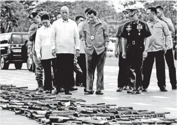  ?? Presidenti­al Photo ?? IN MANILA. President Rodrigo Roa Duterte inspects the firearms recovered from the terrorists who laid siege in Marawi City during the ceremonial demilitari­zation of confiscate­d, surrendere­d, and recovered firearms at the Headquarte­rs Philippine Army...