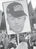  ?? MATT MURSCHEL/ORLANDO SENTINEL ?? A UCF fan holds up a cutout of an unflatteri­ng picture of Kirk Herbstreit’s head wearing a UCF national championsh­ip hat.
