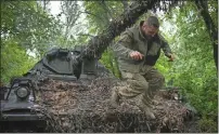  ?? ?? A Ukrainian soldier jumps off the German self-propelled Panzerhaub­itze 2000 artillery at his position at the frontline near Bakhmut, Donetsk region, Ukraine, on Saturday. — ap