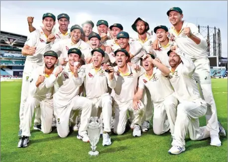  ?? GLYN KIRK/AFP ?? Australia captain Tim Paine holds the Ashes urn after the fourth day of the fifth Test against England at The Oval in London on Sunday. England won the match and drew the series but Australia keep the Ashes by virtue of winning the last series down under.