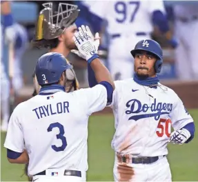  ?? HARRY HOW/GETTY IMAGES ?? Mookie Betts, who hit three home runs against the Padres on Aug. 13, is leading the Dodgers’ potent offense.