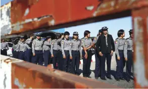  ??  ?? NAYPYITAW: Police officers stand next to a barricade as factory workers gather to stage a protest close to the capital Naypyitaw yesterday. — AP