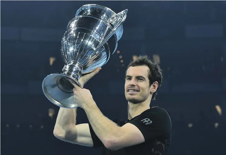  ?? — GETTY IMAGES ?? Andy Murray holds up the ATP World No. 1 trophy after winning the singles final against Novak Djokovic in the ATP World Tour Tournament in London on Sunday.