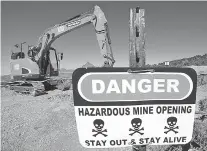  ??  ?? RIGHT: A sign warns of the danger of a mine shaft that is being covered near Eureka, Utah, in May. The state is trying to seal more than 10,000 open mines.