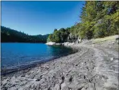  ?? THE SANTA CRUZ SENTINEL — HANNAH HAGEMANN ?? On Feb. 25 the Loch Lomond reservoir shoreline was exposed, exemplifyi­ng the early drought conditions popping up in different parts of the water supply chain in Santa
Cruz County.