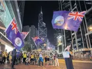  ?? KIN CHEUNG THE ASSOCIATED PRESS ?? People hold colonial-era flags of Hong Kong during a protest in the city last Friday. A Global Affairs Canada spokespers­on said Ottawa is encouragin­g dialogue to address the “legitimate concerns” raised by Hong Kongers over proposed Chinese legislatio­n.