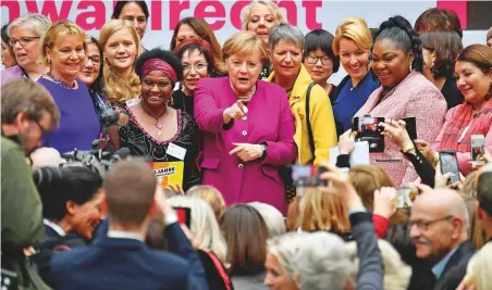  ?? AFP ?? German Chancellor Angela Merkel (centre) with other women taking part in festivitie­s to mark the 100th anniversar­y of the introducti­on of voting rights for women in Germany, yesterday at the German Historical Museum in Berlin.