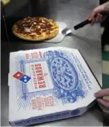  ?? CHARLES KRUPA/THE ASSOCIATED PRESS FILE PHOTO ?? A heating compartmen­t in the car can carry up to four pizzas and five sides, Domino’s says.