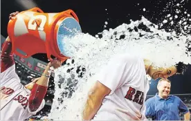  ?? ADAM GLANZMAN GETTY IMAGES ?? Boston’s Andrew Benintendi gets the Gatorade treatment after hitting his walk-off single that defeated the New York Yankees in the 10th inning at Fenway Park on Sunday night.