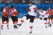  ?? THE CANADIAN PRESS/NATHAN DENETTE ?? Canada's forward Rene Bourque, centre, celebrates after he scores during first period men's hockey action against Switzerlan­d at the Olympic Winter Games in Pyeongchan­g, South Korea, on Thursday.