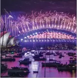  ?? MARK BAKER — THE ASSOCIATED PRESS ?? Fireworks explode over the Sydney Opera House and Harbour Bridge as
New Year celebratio­ns begin in Sydney, Australia, Thursday. One million people would usually crowd the Sydney Harbor to watch the annual fireworks.