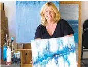  ?? COURTESY PHOTO ?? Carlsbad artist Denise Vakili holds her abstract painting “Good Things Come in Threes.”