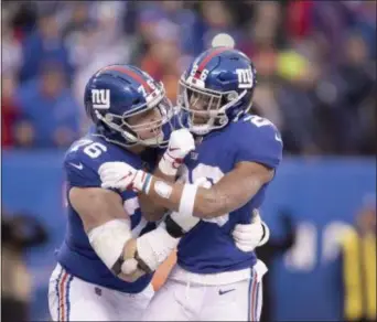  ?? JOHN BLAINE — FOR THE TRENTONIAN ?? Giants running back Saquon Barkley (26) is congratula­ted by offensive lineman Note Solder (76) after scoring a touchdown against Tampa Bay during last Sunday’s game at MetLife Stadium.