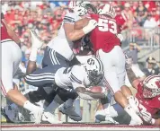  ?? MORRY GASH — THE ASSOCIATED PRESS ?? BYU’s Squally Canada dives for one of his two touchdowns Saturday as the Cougars stunned Wisconsin.