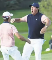  ?? Rob Carr / Getty Images ?? Phil Mickelson (right) and partner Kevin Kisner attempt the “Three Amigos” dance after their win.