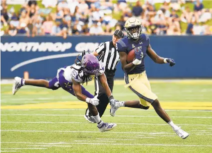  ?? PAULW. GILLESPIE/AP ?? Wide receiver Mychal Cooper and the rest of the Navy offense left East Carolina defenders grasping at air quite often last season in Annapolis.