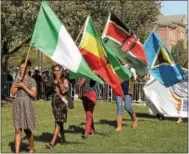  ?? CHRIS BARBER — DIGITAL FIRST MEDIA ?? The academic procession was led by a line of flags representi­ng all the countries that present Lincoln students come from.